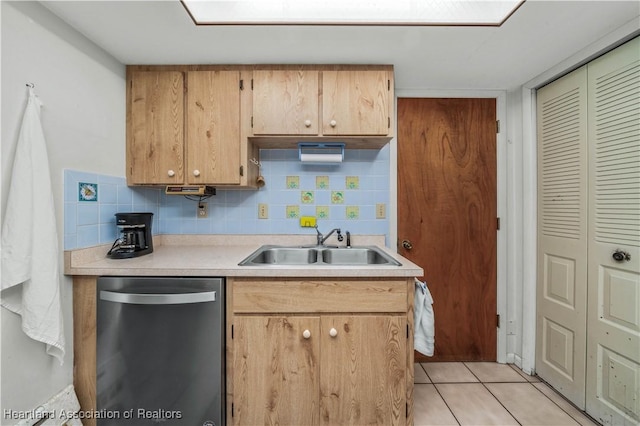 kitchen with stainless steel dishwasher, decorative backsplash, light tile patterned flooring, and sink