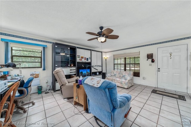 living room with light tile patterned floors, plenty of natural light, and ceiling fan