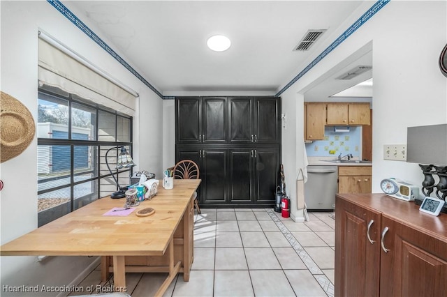 kitchen featuring dishwasher, light tile patterned floors, sink, and tasteful backsplash