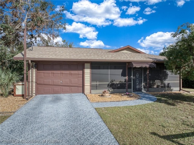 ranch-style home with a front lawn and a garage