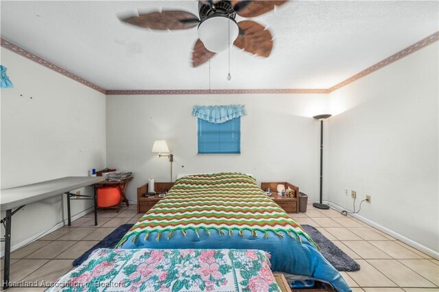 bedroom with tile patterned flooring, ceiling fan, and crown molding