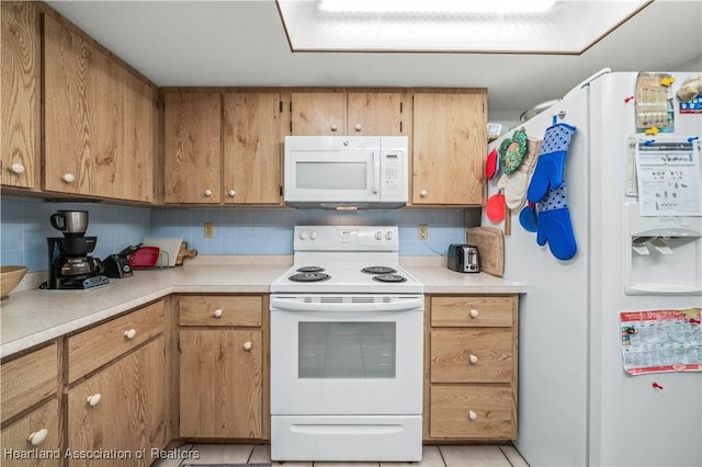 kitchen with decorative backsplash, light tile patterned flooring, and white appliances