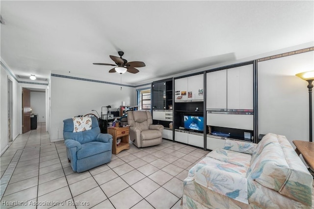 tiled living room with ceiling fan and ornamental molding