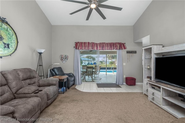 carpeted living room with high vaulted ceiling and ceiling fan