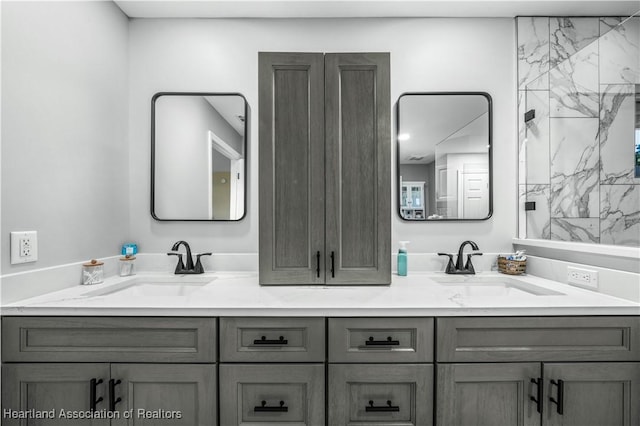 bathroom featuring walk in shower and vanity