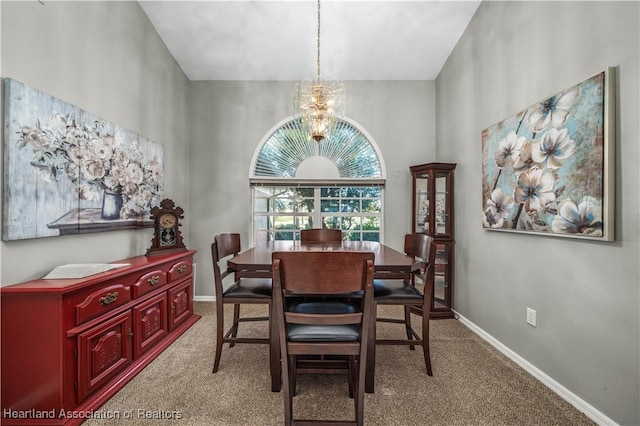 dining room with a chandelier, light carpet, and a high ceiling