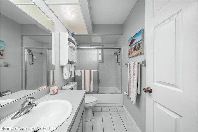 full bathroom with vanity, tile patterned floors, shower / bath combination with glass door, and toilet