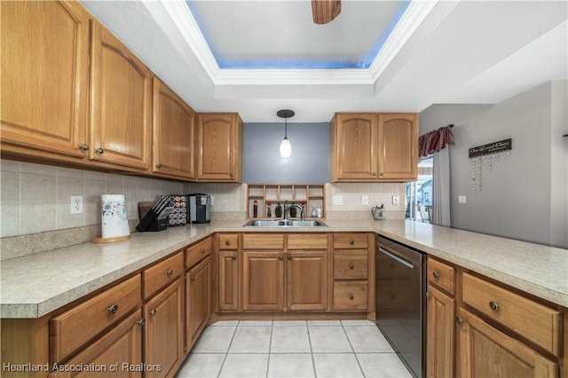 kitchen featuring sink, decorative light fixtures, stainless steel dishwasher, a tray ceiling, and kitchen peninsula