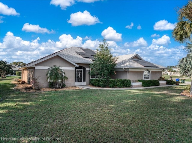 single story home with a front lawn and solar panels