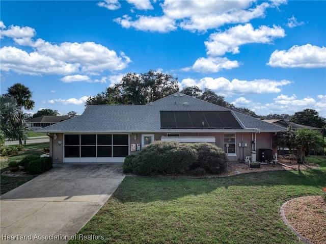 view of front of house with a front lawn and solar panels