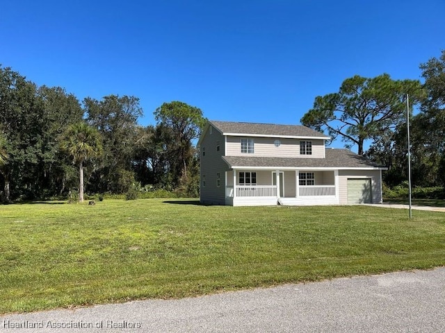 view of front facade featuring covered porch, a garage, and a front yard