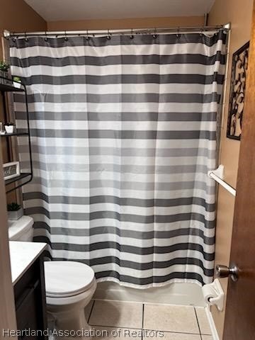 bathroom featuring tile patterned flooring, vanity, and toilet