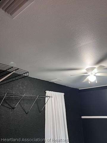 interior details featuring ceiling fan