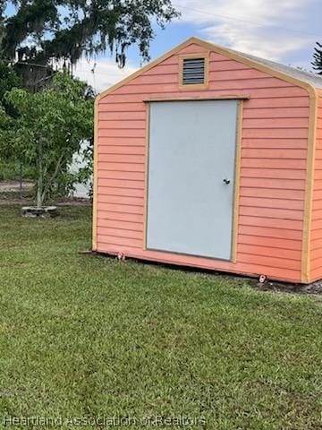 view of outbuilding with a lawn