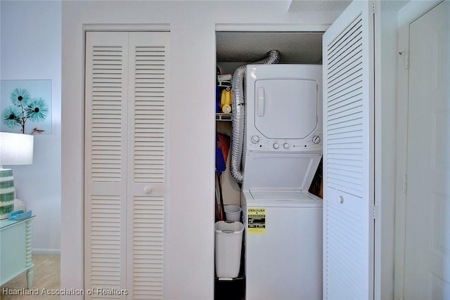 laundry room with laundry area and stacked washer / dryer