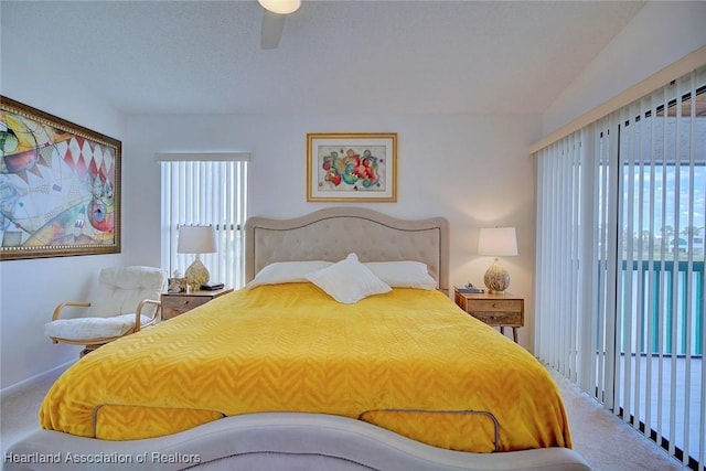 bedroom featuring multiple windows, a ceiling fan, and carpet floors