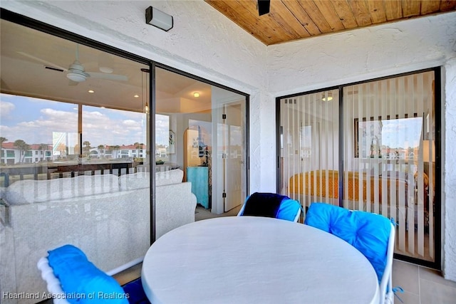 sunroom with visible vents, wood ceiling, and ceiling fan