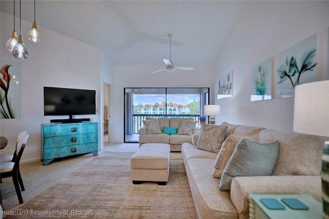 living room with light carpet, high vaulted ceiling, and ceiling fan