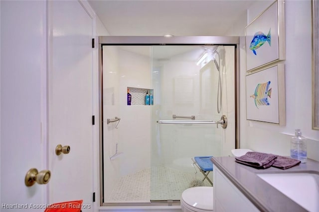 full bath with vanity, toilet, and a stall shower