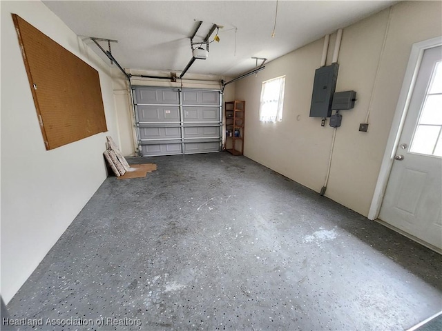 garage featuring electric panel and a garage door opener