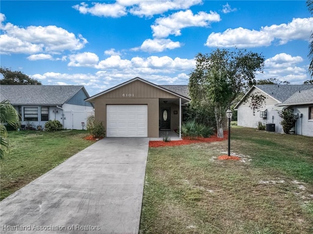 ranch-style house with central AC unit, a garage, and a front yard