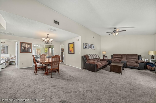 living room featuring carpet flooring, ceiling fan with notable chandelier, and a textured ceiling