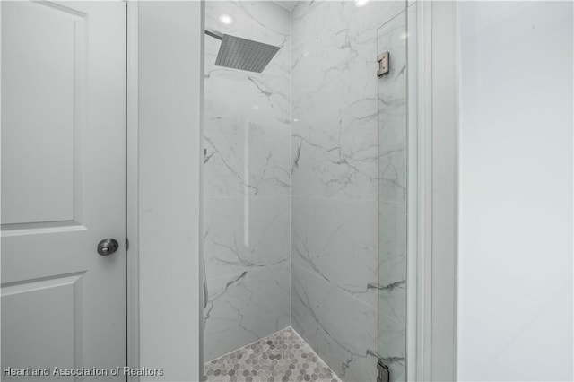 bathroom with a tile shower