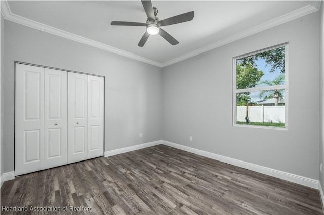 unfurnished bedroom with ceiling fan, a closet, and ornamental molding