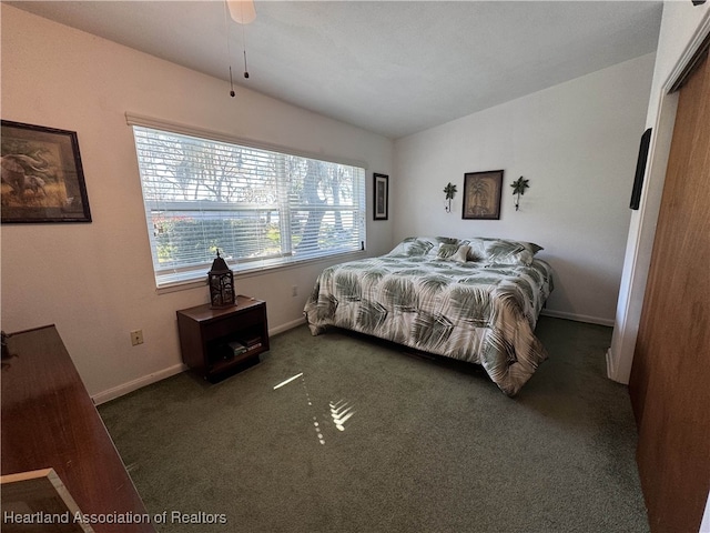 carpeted bedroom with baseboards and vaulted ceiling