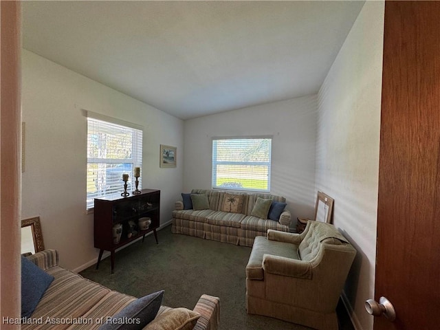 living area with baseboards, lofted ceiling, plenty of natural light, and carpet floors