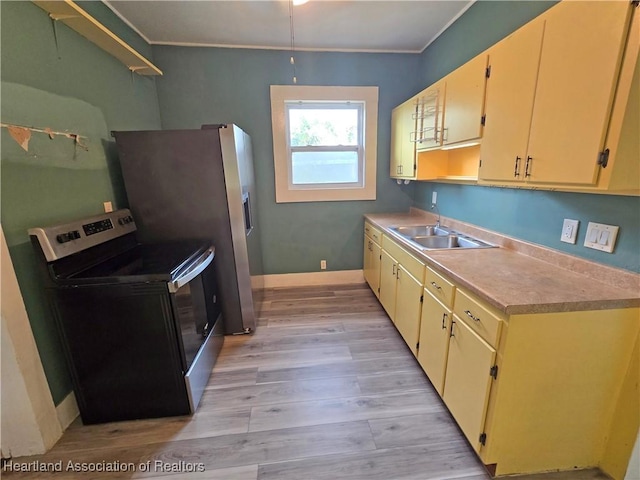 kitchen with ornamental molding, stainless steel appliances, light hardwood / wood-style floors, and sink