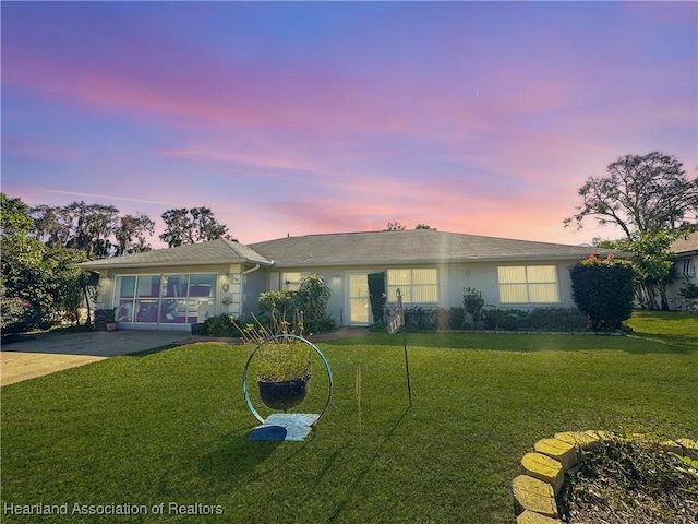 single story home with a lawn