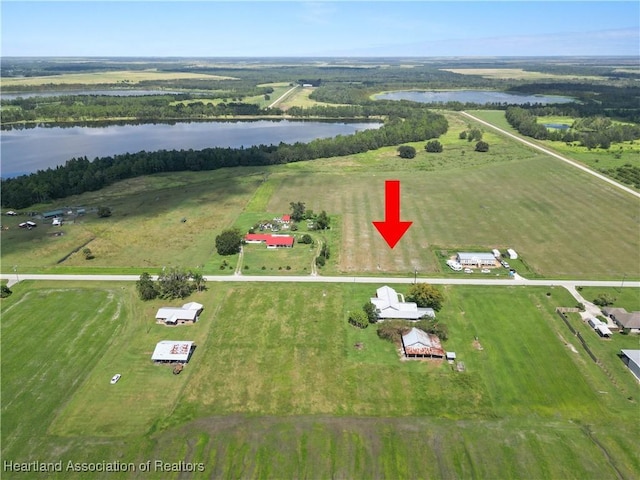 drone / aerial view featuring a water view and a rural view