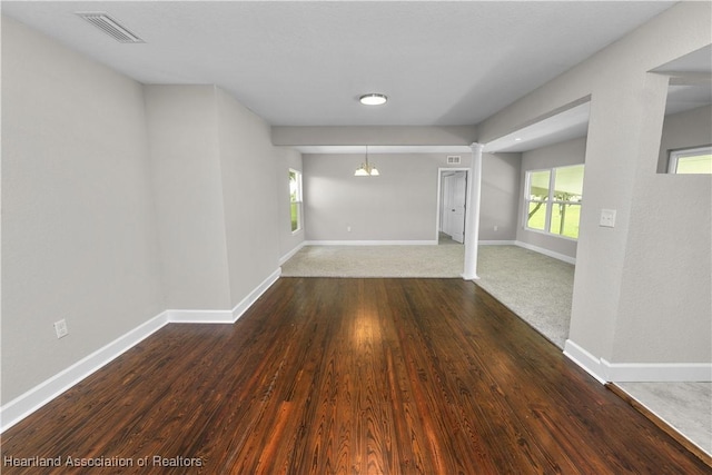 interior space featuring dark hardwood / wood-style floors and an inviting chandelier