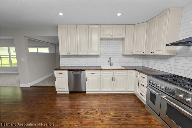 kitchen with tasteful backsplash, sink, white cabinets, and stainless steel appliances