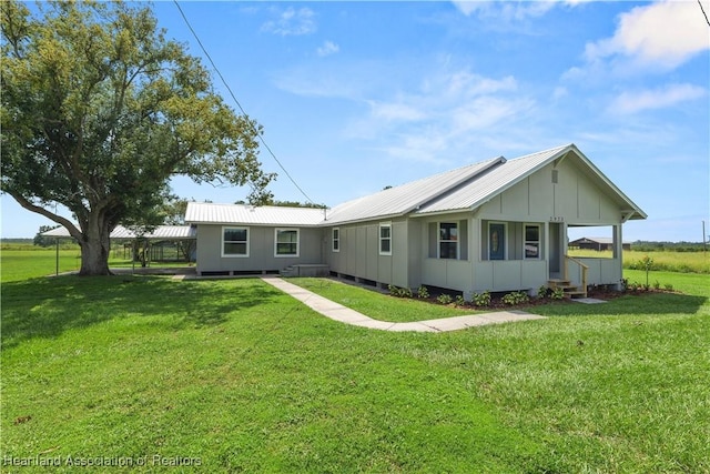 back of house with a lawn