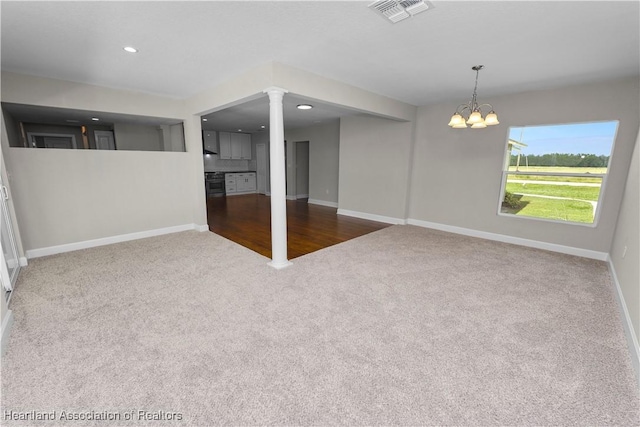 interior space with carpet flooring and a notable chandelier