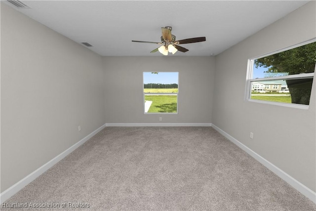 carpeted empty room featuring ceiling fan