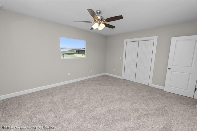 unfurnished bedroom with carpet flooring, ceiling fan, and a closet