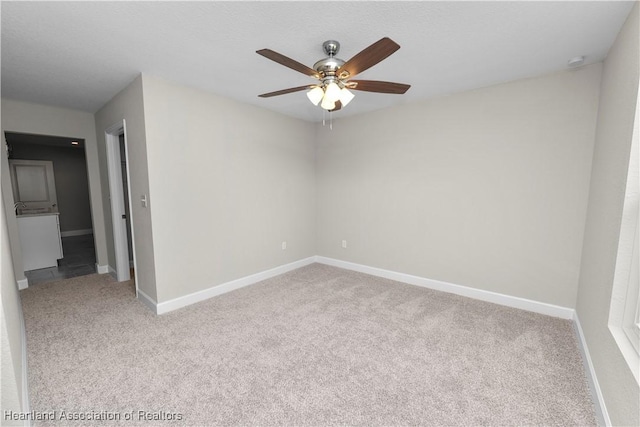 carpeted empty room featuring ceiling fan