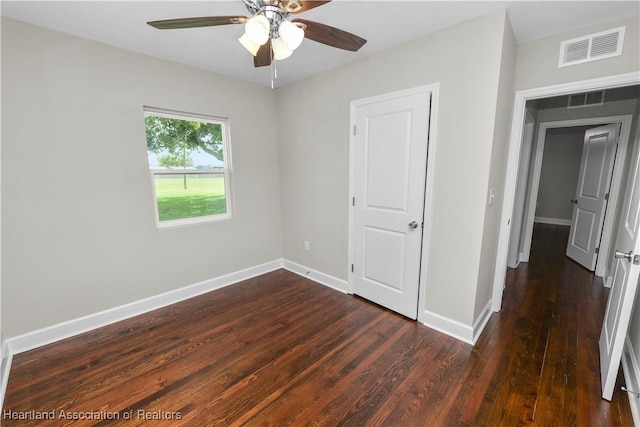 unfurnished bedroom featuring ceiling fan and dark wood-type flooring