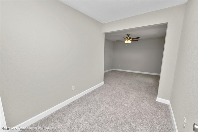 unfurnished room featuring light colored carpet and ceiling fan