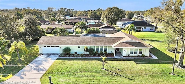 single story home featuring a garage and a front yard