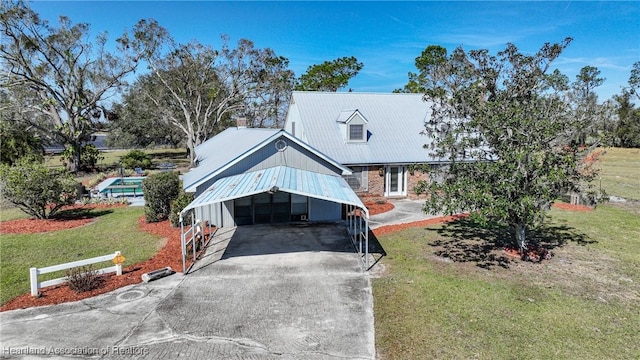 3150 Schontag Rd, Wauchula, FL 33873 - view of front of property with metal roof, a front lawn, and concrete driveway
