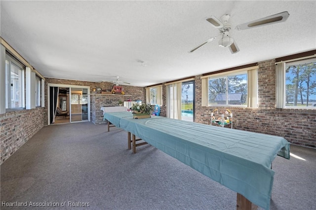 3150 Schontag Rd, Wauchula, FL 33873 - playroom featuring carpet flooring, a textured ceiling, and brick wall
