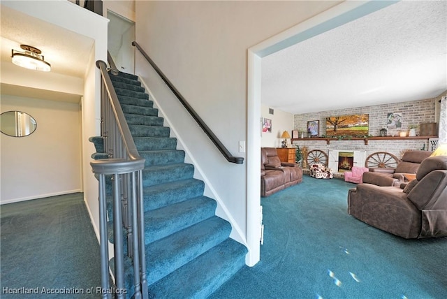3150 Schontag Rd, Wauchula, FL 33873 - stairs with a textured ceiling, brick wall, a fireplace, carpet flooring, and baseboards