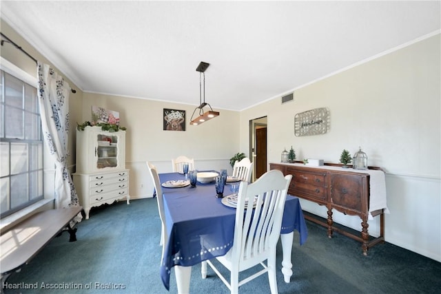 3150 Schontag Rd, Wauchula, FL 33873 - carpeted dining room featuring ornamental molding and visible vents