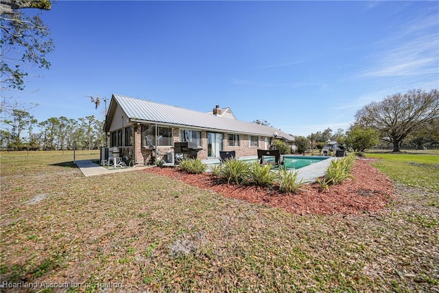 3150 Schontag Rd, Wauchula, FL 33873 - back of house with a yard, a chimney, a patio, and an outdoor pool