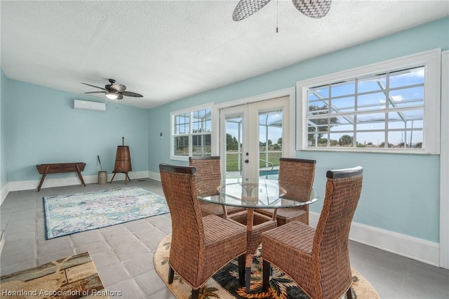 dining area with ceiling fan, a textured ceiling, a wall mounted AC, and french doors