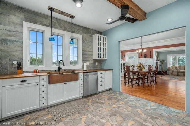 kitchen with dishwasher, white cabinetry, hanging light fixtures, and sink